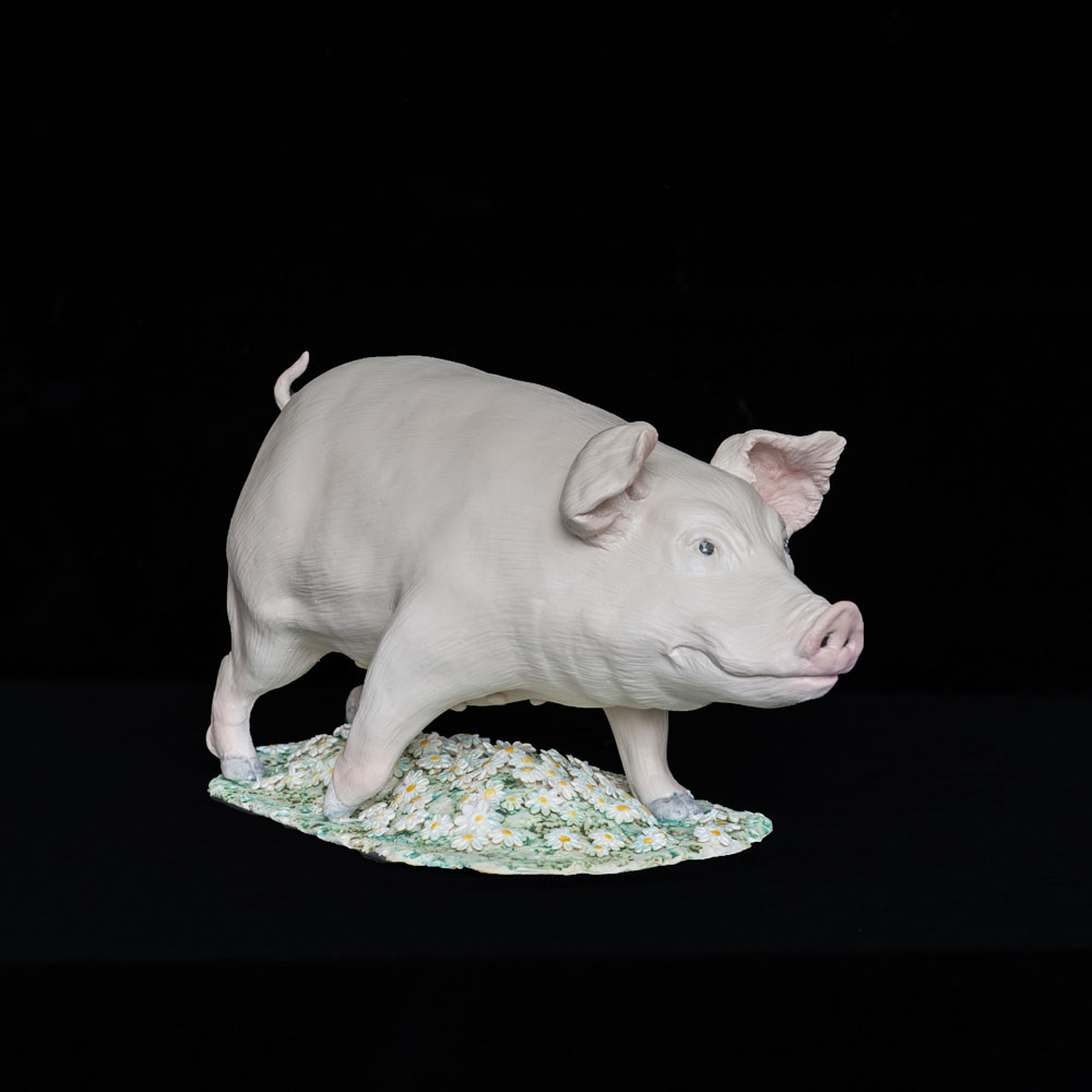 Figurative ceramic sculpture of a pig in daisies